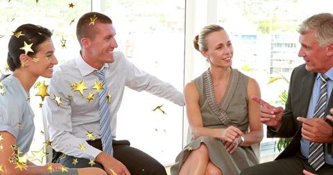 Discussing Strategy: Business Team Collaborating in Sunlit Modern Office with Gold Stars