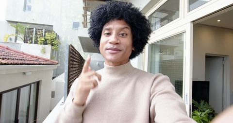 Happy Man Taking Selfie on Modern Urban Balcony