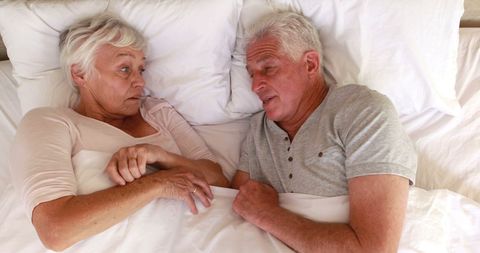 Senior Couple Relaxing and Connecting in Comfortable Bed