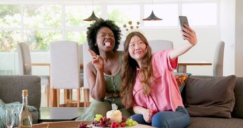 Interracial Lesbian Couple Taking Selfie at Birthday Celebration