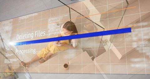 Woman sitting on stairs using smartphone with progress overlay and glass reflections