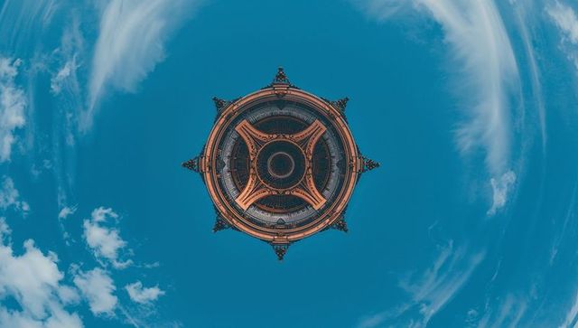 Floating ornate rotunda against blue sky, symmetrical circular dome with radial turrets