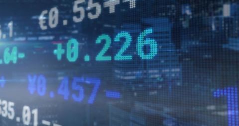 Digital ticker of global exchange values against urban night skyline