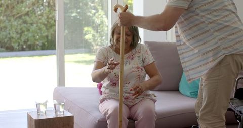 Elderly Woman Receiving Support at Bright Home near Large Picture Window