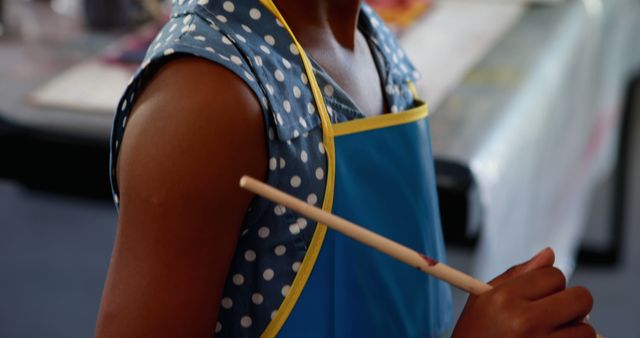 Child in Blue Apron Holding Paintbrush - Download Free Stock Images Pikwizard.com