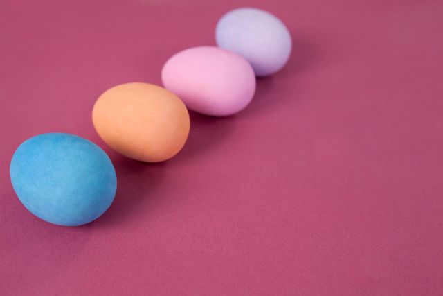 Colorful Easter eggs arranged on pink background