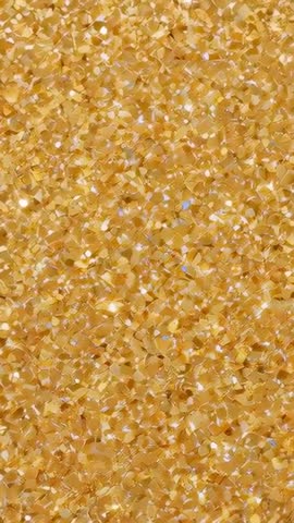 Shimmering Gold Sequin Flakes Shifting Under Studio Light - Vertical Macro Video