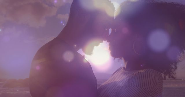 Composition of glowing lights over african american couple touching heads on beach. Vacation, love and romance concept digitally generated image.