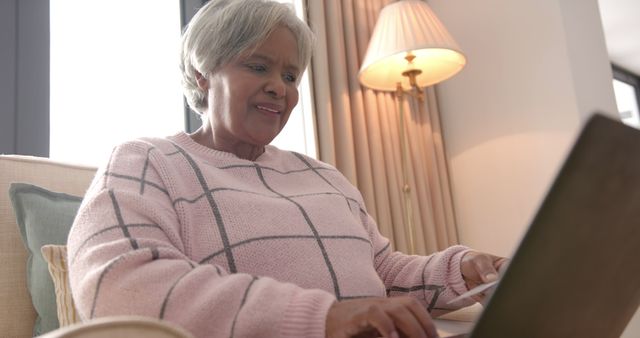 Elderly Woman Smiling While Using Laptop at Home - Download Free Stock Images Pikwizard.com