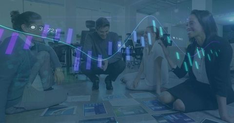 Diverse Team Analyzing Data Visualization on Office Floor