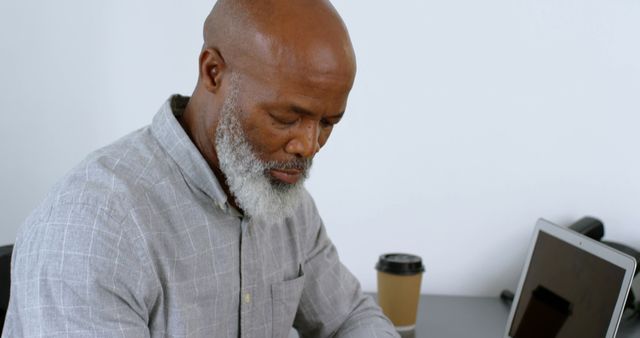 Thoughtful Man with Laptop and Coffee in Office - Download Free Stock Images Pikwizard.com