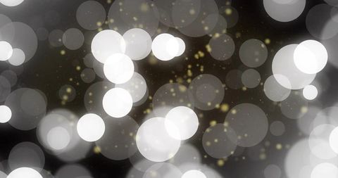 Ethereal bokeh lights with golden sparkles minimalist glow background soft dreamy circles