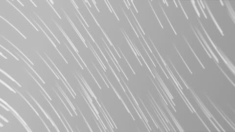 Light Trails Moving Across Grey Background