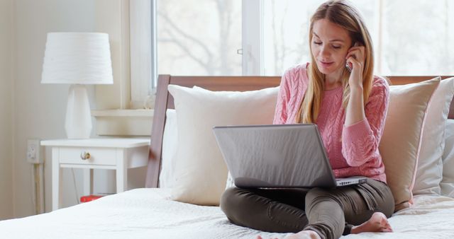 Woman on Bed Working on Laptop and Talking on Phone - Download Free Stock Images Pikwizard.com