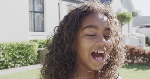 Happy Girl Laughing Outdoors on Sunny Day Near House - Download Free Stock Images Pikwizard.com