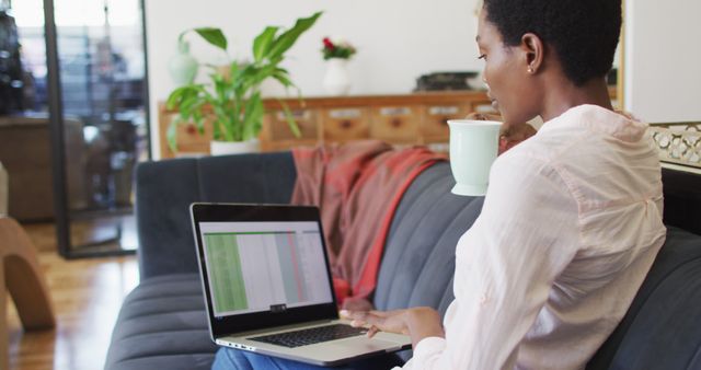 Young Woman Working on Laptop from Home while Drinking Coffee - Download Free Stock Images Pikwizard.com