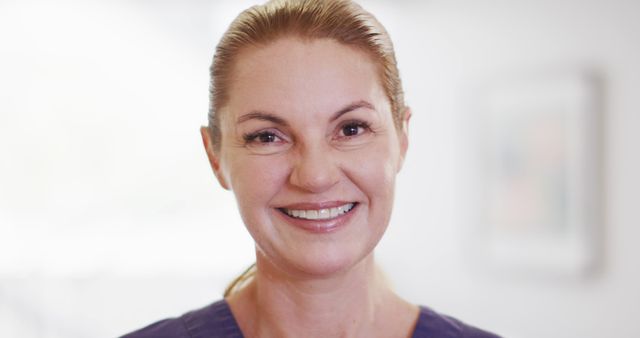 Image portrait of happy caucasian female doctor smiling in hospital, with copy space. Hospital, medical and healthcare services.