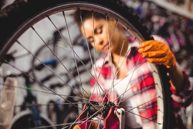 Bicycle Mechanic Repairing Wheel in Workshop - Download Free Stock Images Pikwizard.com