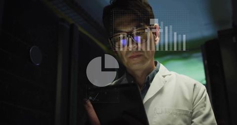 Scientist analyzing data on tablet in server room