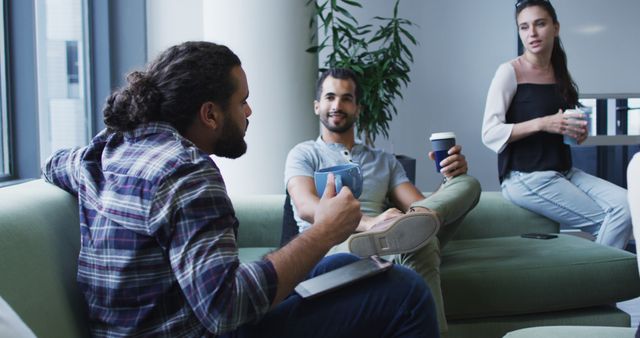 Young adults enjoying casual coffee break in office lounge - Download Free Stock Images Pikwizard.com