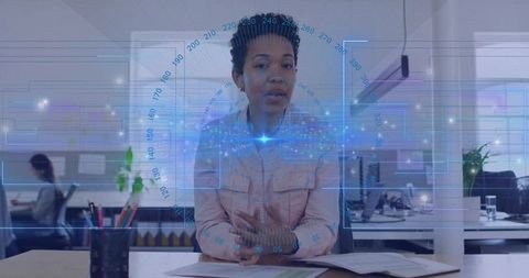 Presenting woman gesturing and explaining data with holographic interface in open office
