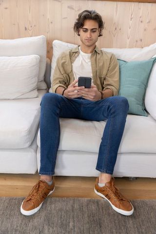 Casual Relaxation at Home with Smartphone and Beaded Bracelet