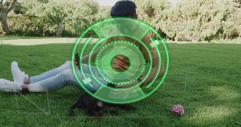 Asian man relaxing on park lawn with smartphone and puppy, augmented reality hud overlay