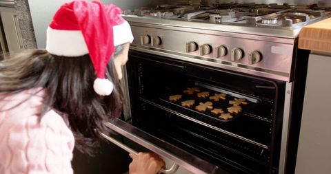 Holiday baking gingerbread cookies santa hat in festive kitchen