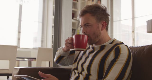 Man Enjoying Coffee at Home in a Cozy Living Room - Download Free Stock Images Pikwizard.com