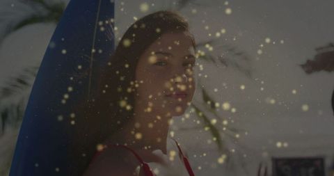 Woman in Red Swimsuit with Surfer Board Amid Golden Light Bokeh at Beach
