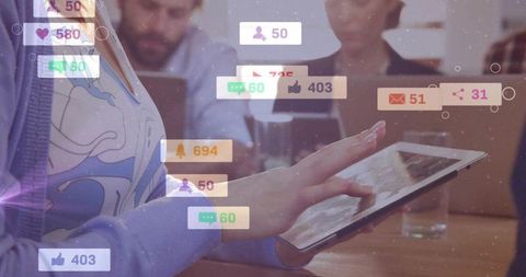 Woman tapping tablet with social notifications overlay at coworking, team collaboration