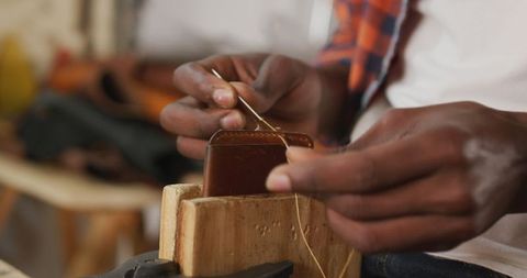 Artisan Crafting Leather Wallet with Skilled Hands in Workshop