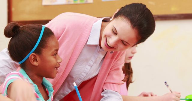 Smiling Teacher Helping Student in Classroom Setting - Download Free Stock Images Pikwizard.com