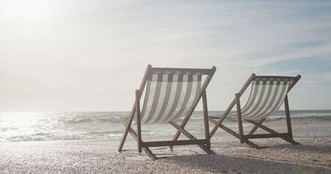 Empty Deckchairs on Secluded Beachside During Sunset - Download Free Stock Images Pikwizard.com
