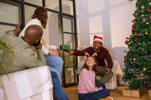 Diverse Family Exchanging Gifts in Cozy Christmas Living Room