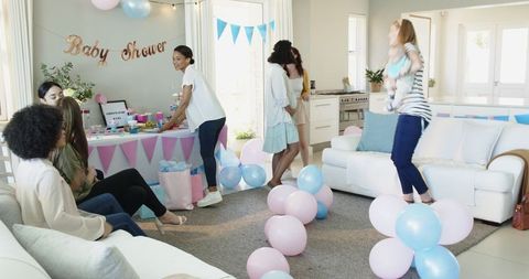 Joyful Group of Friends Celebrating Baby Shower with Decorations