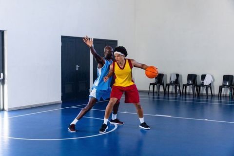Intense Basketball Game with Energetic Athletes on Indoor Court
