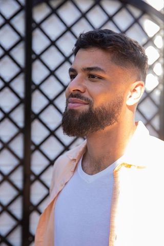 Casual Fashionable Man Standing Outdoors in Natural Light