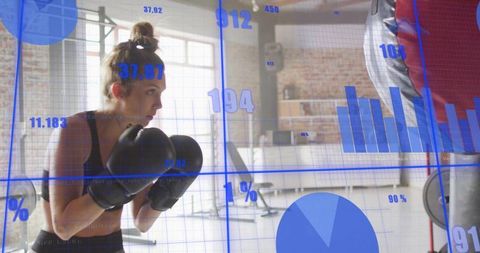Female boxer training with fitness data overlays in loft gym for performance tracking