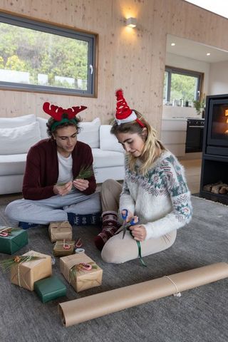 Couple Crafting Christmas Gifts in Cozy Living Room