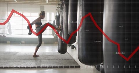 Woman Boxing with Punching Bag Over Financial Graph