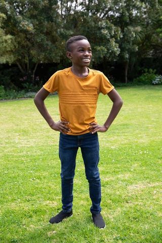 Youth Embracing Nature with Smiling Optimism on Sunny Lawn