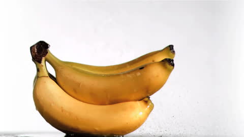 Fresh Bananas in Slow Motion Splash with Water