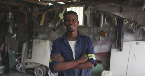 Confident African Male Panel Beater in Workshop Smiling - Download Free Stock Images Pikwizard.com
