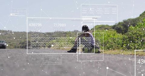 Woman sitting on roadside with futuristic digital overlays