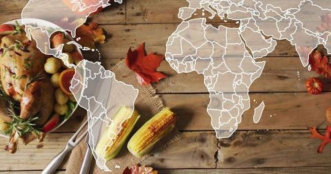 Showcasing rustic harvest table with roasted turkey, grilled corn and world map overlay