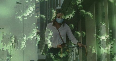 Masked commuter walking with bicycle through office corridor with green virus overlay