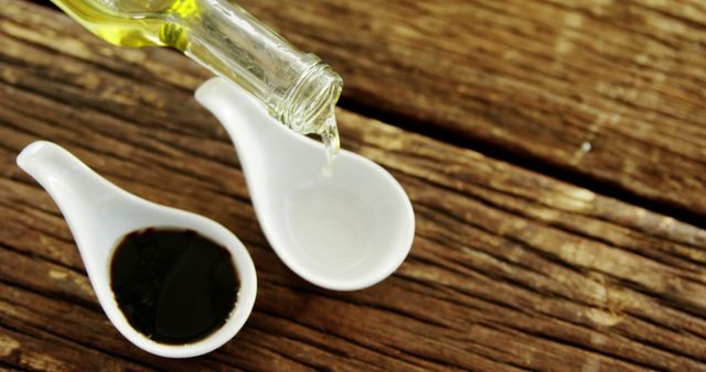 Close-up of Olive Oil Pouring into Ceramic Dish with Soy Sauce - Download Free Stock Images Pikwizard.com