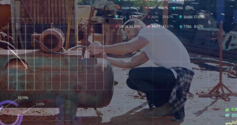 Mechanic Working in Junkyard with Stock Market Animation Overlay