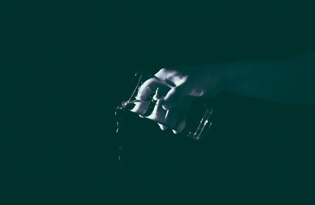 Hand Holding Glass with Water Pouring Out Against Dark Background - Download Free Stock Images Pikwizard.com